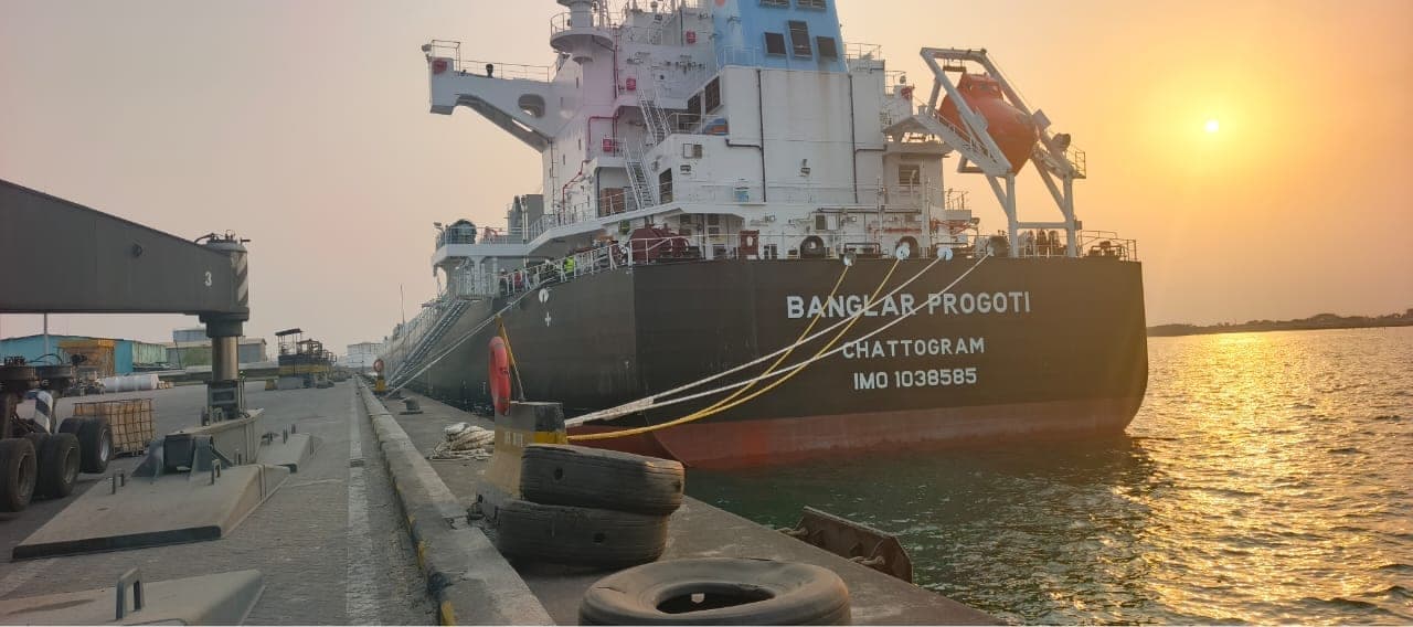 Bulk carrier vessel berthed at port at sunset